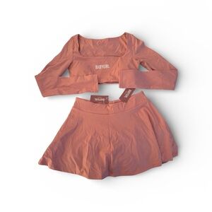 Women's Pink Two-Piece Set with built in shorts with pockets.